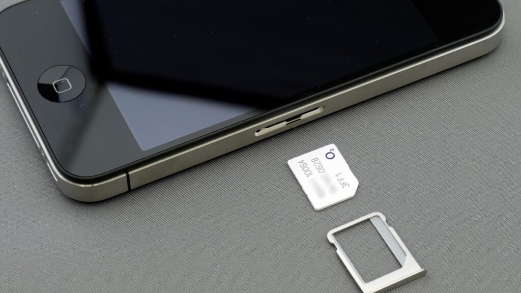 Airalo and Holafly Expand Coverage for Travel eSIM Apps mobile phone running travel eSIM apps